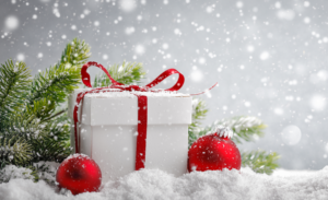 White gift box and christmas balls on snow
