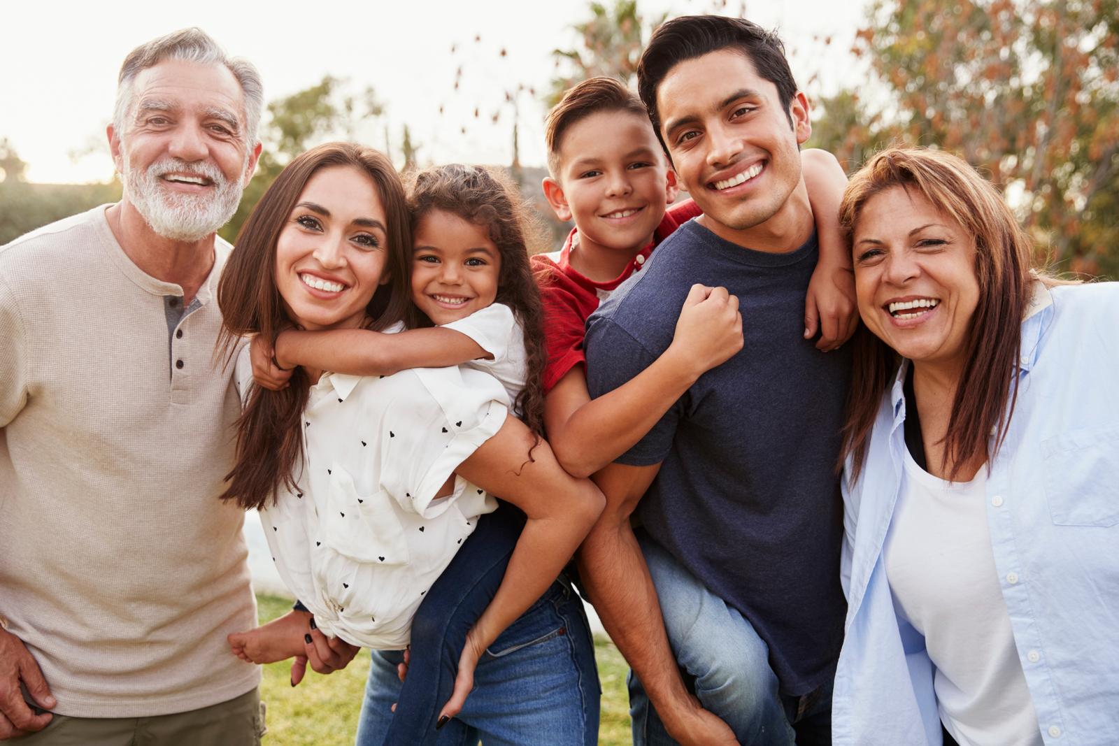 Portrait of a Latin family hugging in rural area - Happy Hispanic family in the village